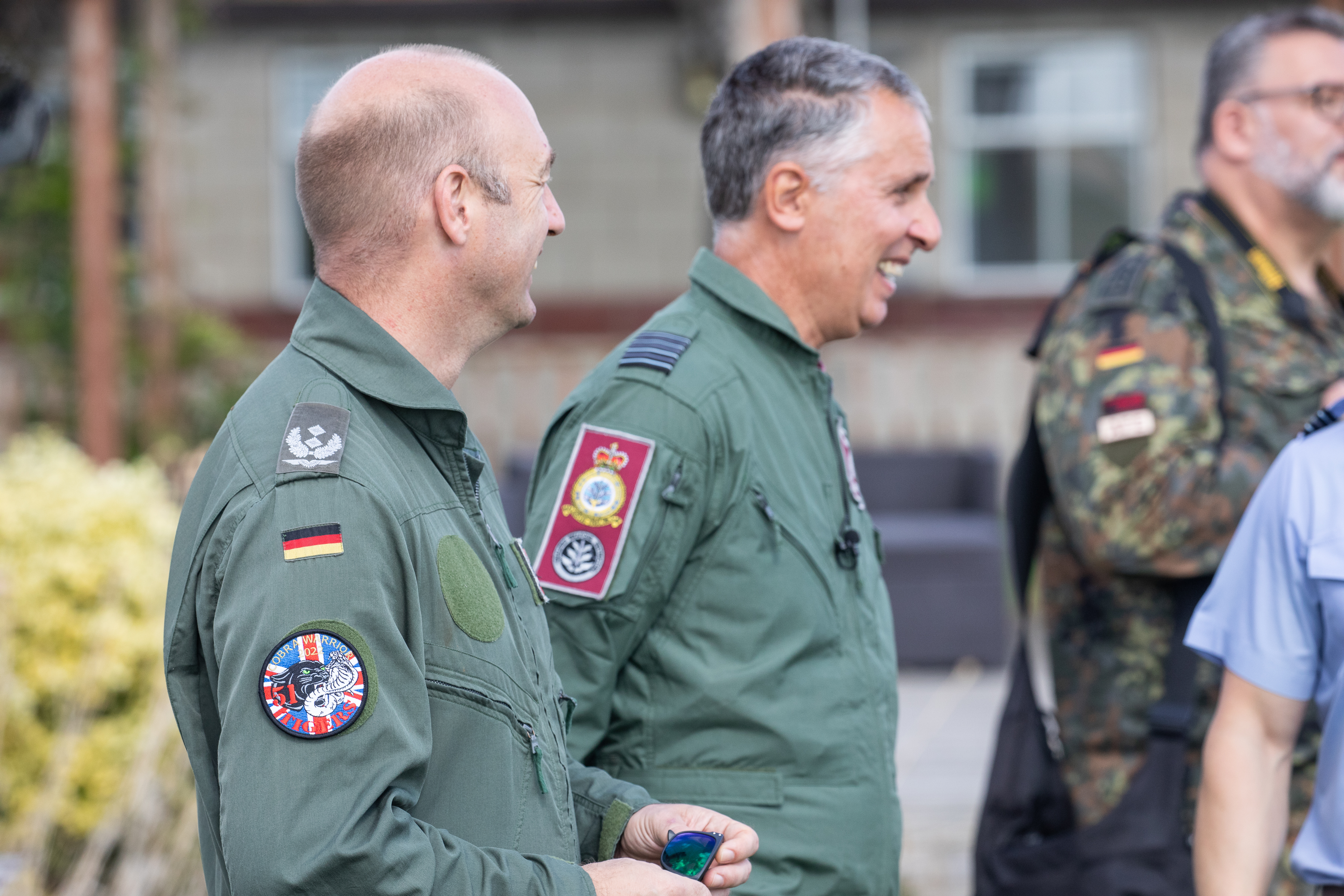 Image shows personnel standing together smiling.